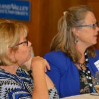 Two alumnae sitting at a table